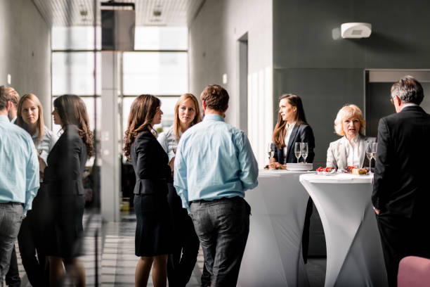 Business professionals networking in a modern office space, reflecting collaboration in a "free zone."