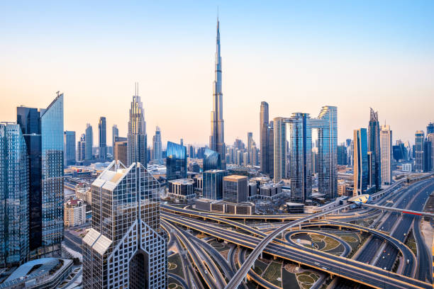 Aerial view of Dubai's cityscape showcasing modern skyscrapers and highways at dawn.